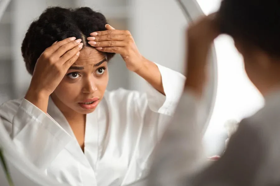 Young Black Woman Checking Her Hair