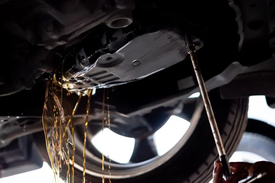 Auto Mechanic Drain Automatic Transmission Fluid