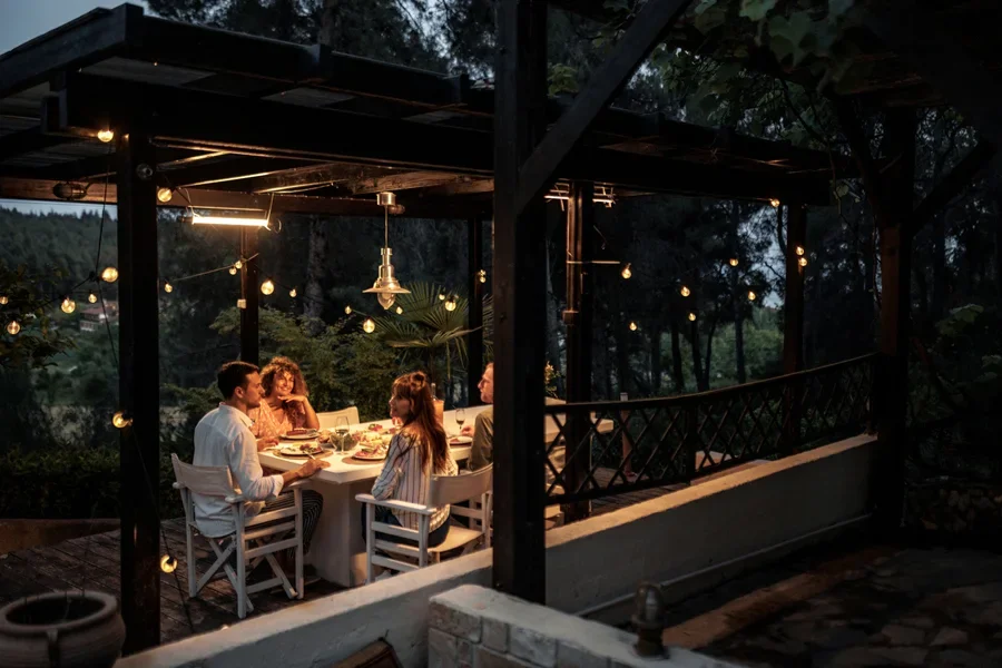 Group of Friends Having Dinner on the Patio in the Backyard