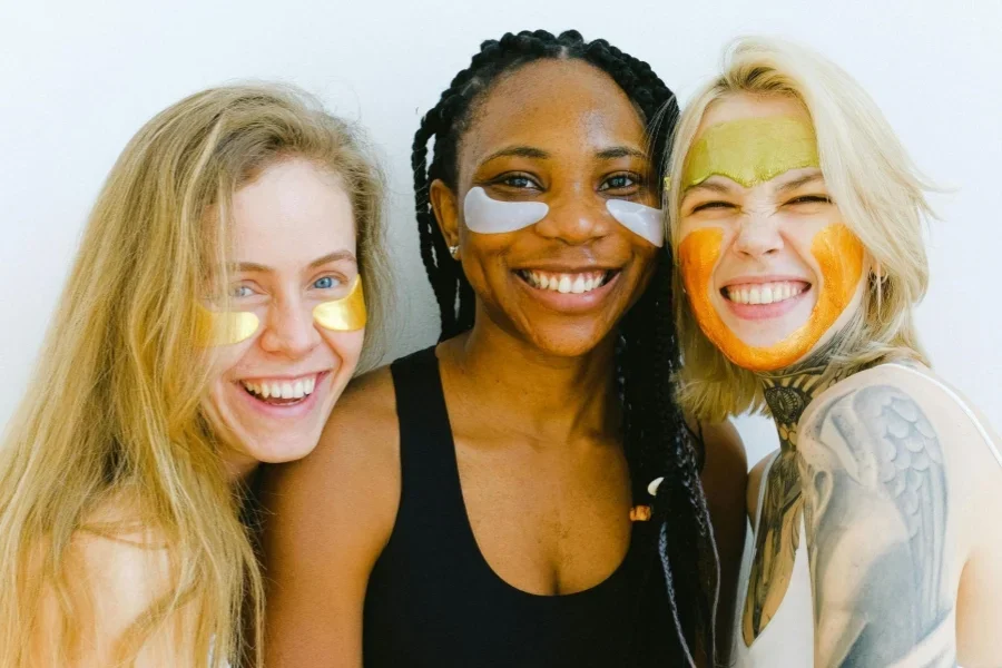 Happy women with cosmetic masks on face