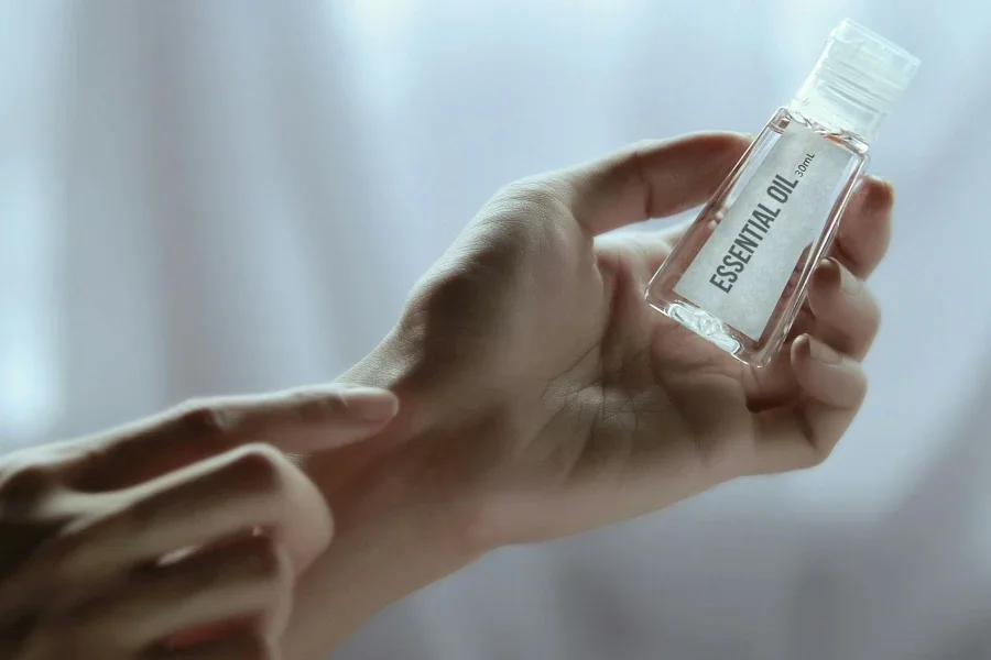 Person Holding Plastic Bottle